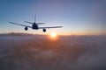 Flying of the passenger plane above the clouds and mountains Royalty Free Stock Photo