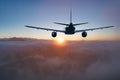 Flying of the passenger plane above the clouds and mountains Royalty Free Stock Photo