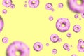 Flying pink doughnuts from plasticine on bright light yellow background. Minimal summer concept. Banner with copy space for