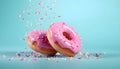 Flying pink sprinkled donuts. Sweet doughnut on pastel blue background