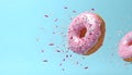 Flying pink sprinkled donuts. Sweet doughnut on pastel blue background