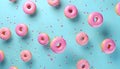 Flying pink sprinkled donuts. Sweet doughnut on pastel blue background