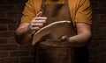 Flying pizza dough with flour scattering in a freeze motion of a cloud of flour midair on black. Cook hands kneading dough. copy Royalty Free Stock Photo