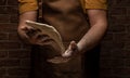 Flying pizza dough with flour scattering in a freeze motion of a cloud of flour midair on black. Cook hands kneading dough. copy Royalty Free Stock Photo