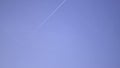 Flying plane on blue sky - trail, hemtrails