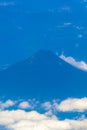 Flying by plane over Mexico view of volcanoes mountains clouds Royalty Free Stock Photo