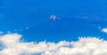 Flying by plane over Mexico view of volcanoes mountains clouds Royalty Free Stock Photo