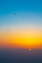 Flying plane at sunset sky Royalty Free Stock Photo