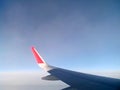 Flying on a plane. The view from the window. Blue sky with clouds.