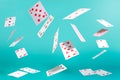 Flying playing cards on a turquoise background