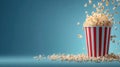 Flying popcorn exploding from a classic red and white striped bucket against a blue background with copy space Royalty Free Stock Photo