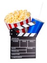 Flying popcorn and film clapper board isolated on white background