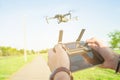 Flying quadcopter drone with Action Camera in the air under blue sky and remote control in the hands Royalty Free Stock Photo