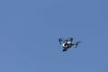 Flying a quadcopter is videotaping against the blue sky Royalty Free Stock Photo