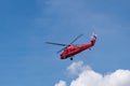 Flying red rescue helicopter against a clear blue sky Royalty Free Stock Photo