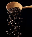 Flying roasted coffee grains on a black background