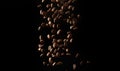 Flying roasted coffee grains on a black background