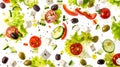 Flying salad isolated on white background Greek salad: red tomatoes, pepper, cheese, lettuce, cucumber, olives, and olive oil Royalty Free Stock Photo
