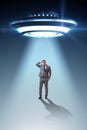 The flying saucer abducting young businessman Royalty Free Stock Photo