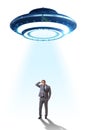 The flying saucer abducting young businessman Royalty Free Stock Photo