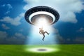 The flying saucer abducting young businessman Royalty Free Stock Photo