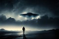 Flying saucer flies at night in sky oversilhouette of man standing in field. Invasion of extraterrestrial intelligence Royalty Free Stock Photo