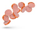 Flying sausage. Slices of smoked sausage on a white isolated background. Salami slices fall on a white background, for