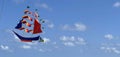 flying ship, rainbow colored ship kite flies on the blue sky and cloud Royalty Free Stock Photo