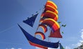 flying ship, rainbow colored ship kite flies on the blue sky and cloud Royalty Free Stock Photo