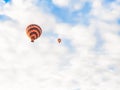 Flying in sky many bright colored beautiful balloons into air in Cappadocia in mountains early at sunrise, dawn. Filling