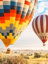 Flying in sky many bright colored beautiful balloons into air in Cappadocia in mountains early at sunrise, dawn. Filling