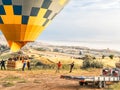 Flying in sky many bright colored beautiful balloons into air in Cappadocia in mountains early at sunrise, dawn. Filling