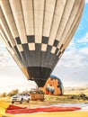 Flying in sky many bright colored beautiful balloons into air in Cappadocia in mountains early at sunrise, dawn. Filling