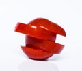 Flying slices of fruit: tomato on isolated white background.