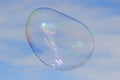 Flying soap bubble with reflection of the blue sky Royalty Free Stock Photo