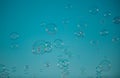 Flying soap bubbles on sky blue background. Royalty Free Stock Photo