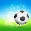 Flying soccer ball over green and blue sky landscape Royalty Free Stock Photo