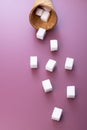 Flying sugar. Flying sugar cubes from ice cream cone on red background. Copy space for text. Top view. Vertical Royalty Free Stock Photo