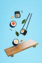 Flying sushi, wooden plate and chopsticks, blue