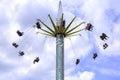 People enjoy a ride on a flying swing ride at an amusement park