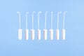 Flying tampons. Menstrual period concept. Woman hygiene protection. Women`s health. Cotton tampons on blue background. Front view
