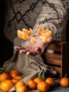 Flying tangerine slices over a male hand on a black background