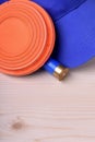 Flying target plate for shotgun sport, blue cap and a shell