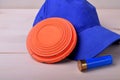 Flying target plate for shotgun sport, blue cap and a shell