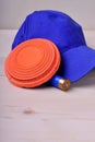 Flying target plate for shotgun sport, blue cap and a shell