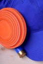 Flying target plate for shotgun sport, blue cap and a shell