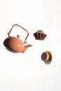 Flying teapot, cake, cup on a white background.