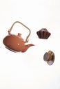 Flying teapot, cake, cup on a white background.