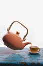 Flying teapot, tea cup. To pour tea. Drops. White background. Royalty Free Stock Photo