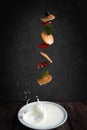 flying tiny pancakes on a dark background, small pancakes with strawberries Royalty Free Stock Photo